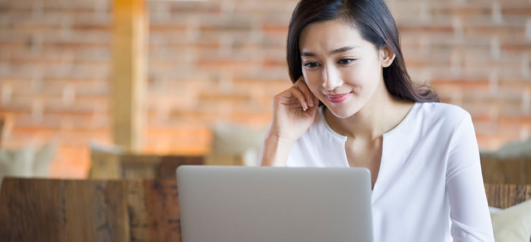 Woman smiling on laptop