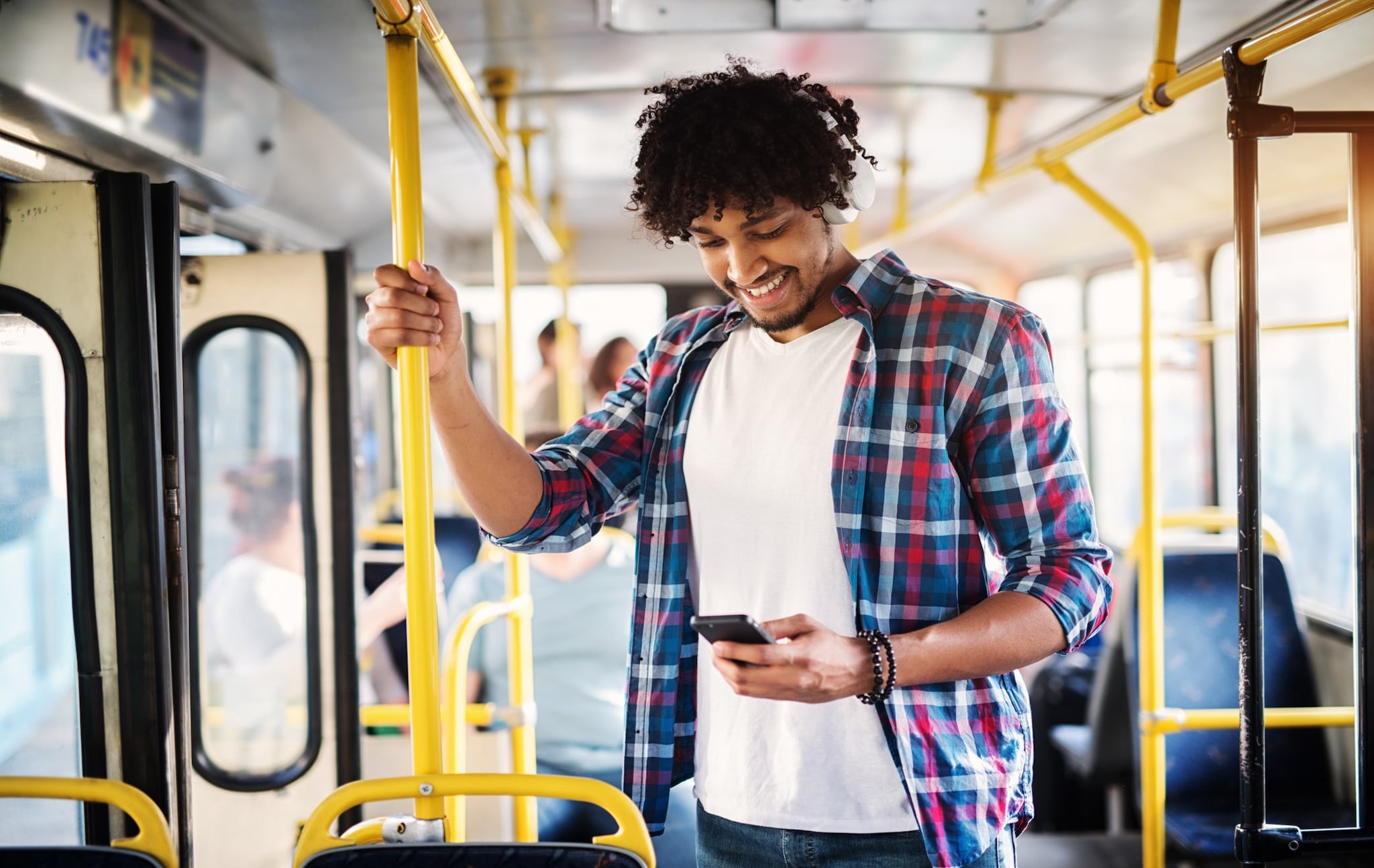  A man looking at his phone screen and smiling.
