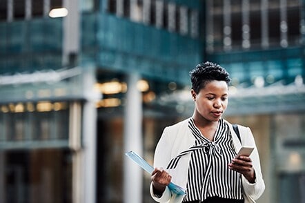 A lady looking at her smartphone for notifications.