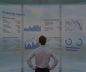 Male looking up at Financial Report 