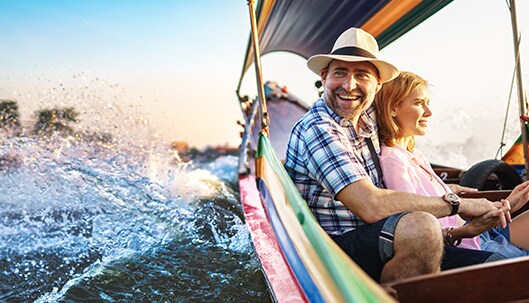 A couple holding hands on a boat at sea