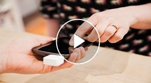 Man packing jeans into suitcase