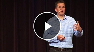 Man packing jeans into suitcase