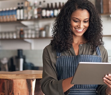 Shop owner looking at tablet