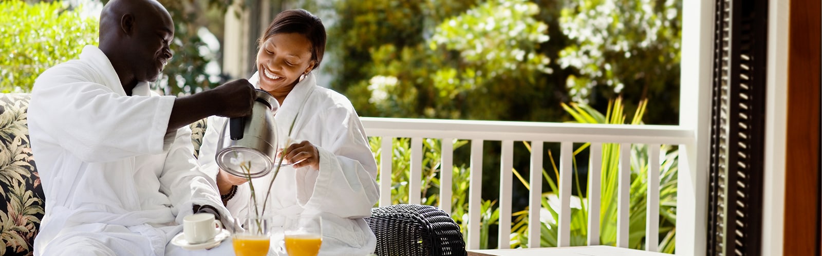 A couple enjoys breakfast in their bathrobes