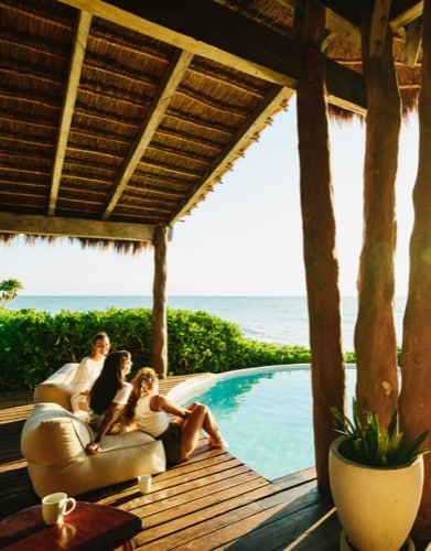 two men guiding the child to do carpentry