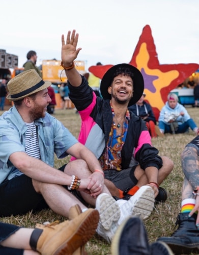 two men guiding the child to do carpentry