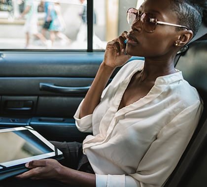 Woman in card on phone