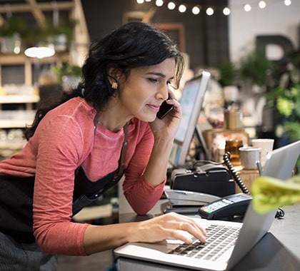 Woman on phone and laptop