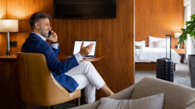 Individual on a phone call in hotel room