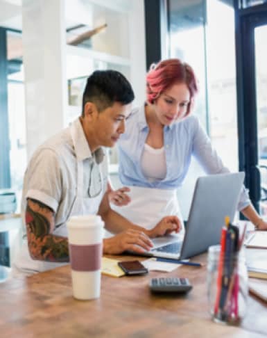 two people working in a laptop