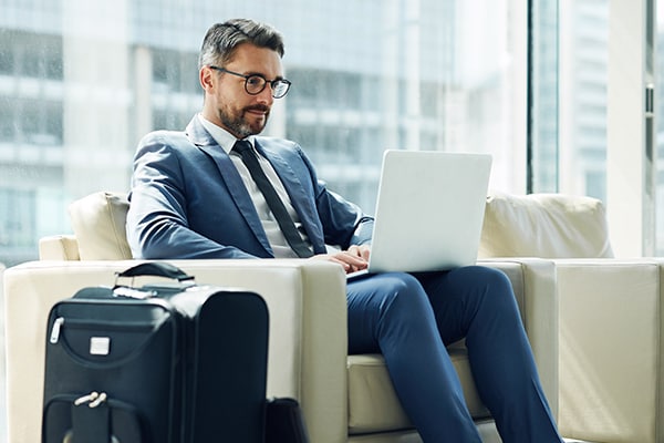 Man in suit using his laptop