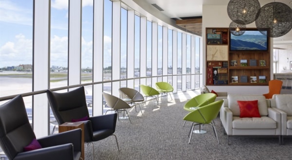  Row of four comfortable chairs inside airport lounge