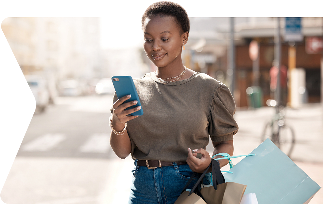 Person on mobile device with shopping bags