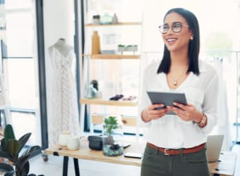 Woman in retail shop holding tablet device