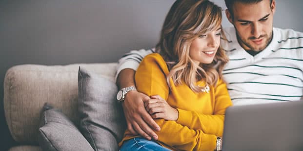 A couple looking at a laptop