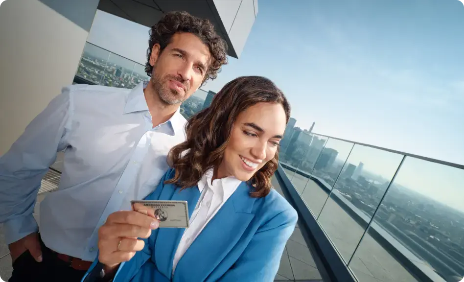 Geschäftsfrau hält eine Business Platinum Card und lächelt