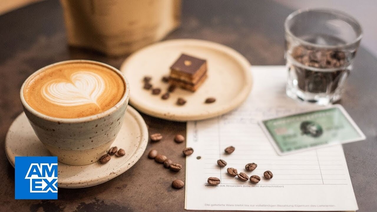 coffee cup on table with AMEX card ned to bill