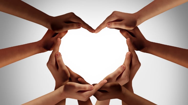 Many hands coming together to form a heart
