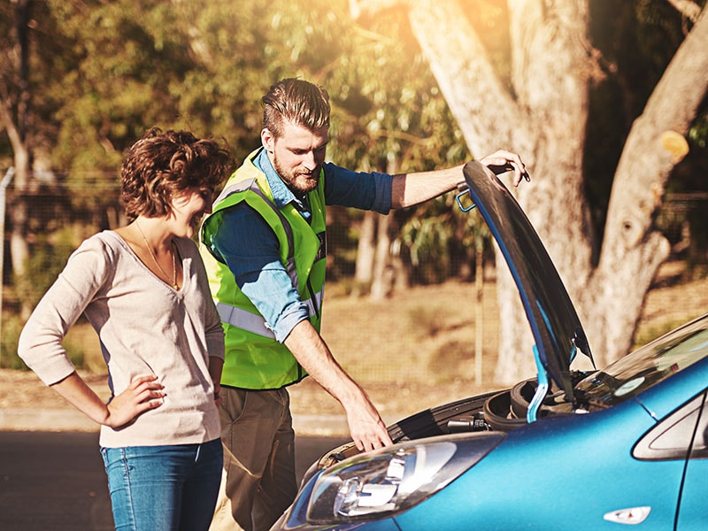  Woman receiving help on vehicle.