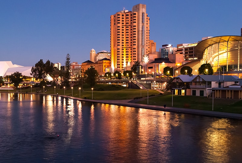 Adelaide Riverbank Precinct at night with city lights reflecting on the water.