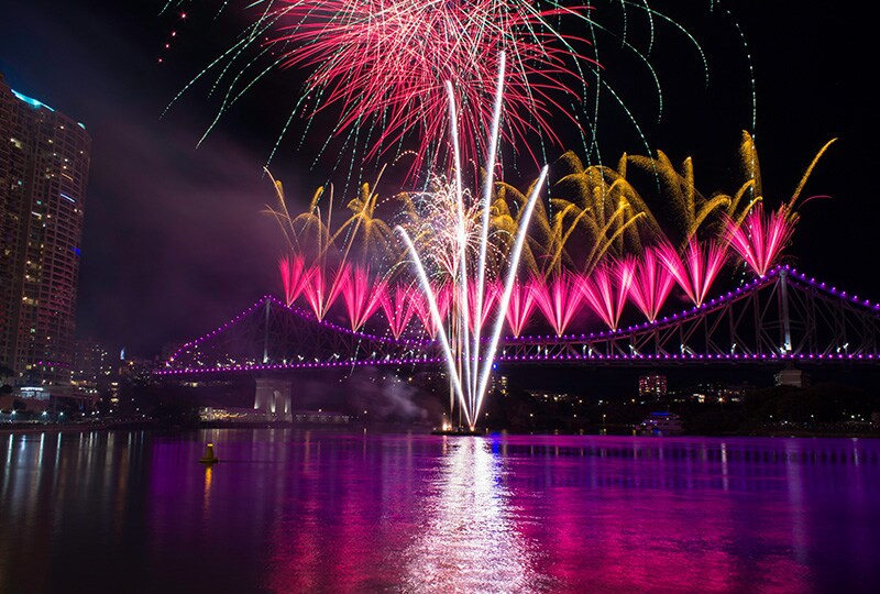 Brisbane skyline illuminated at twilight with reflections over the Brisbane River.