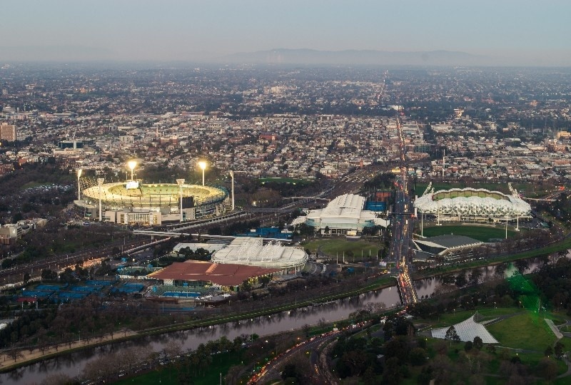 Aerial view of Melbourne sports precinct including the MCG and surrounding arenas.