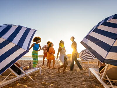 A group of people laughing on a beach