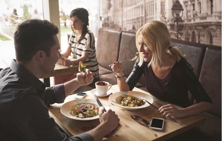 smiling couple enjoying lunch at a restaurant