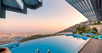Pool overlooking city with sunset         