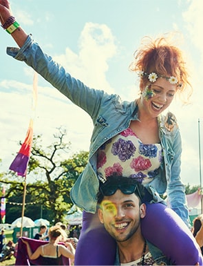 Girl sitting on boys shoulder