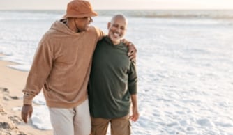 Man sitting on window sill holding tablet