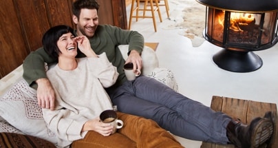 Two people relaxing with warm beverages.