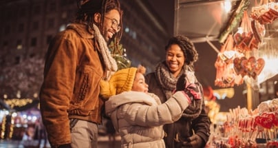 Family shopping at a holiday market.