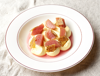 Delicately plated crudo on a bed of gazpacho