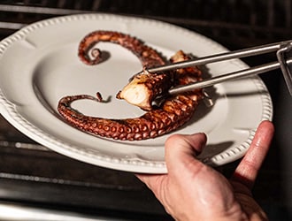 Delicately plated crudo on a bed of gazpacho