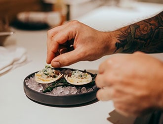 Delicately plated crudo on a bed of gazpacho