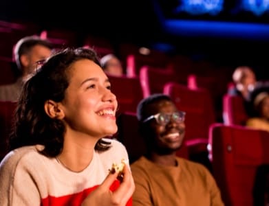 two men guiding the child to do carpentry