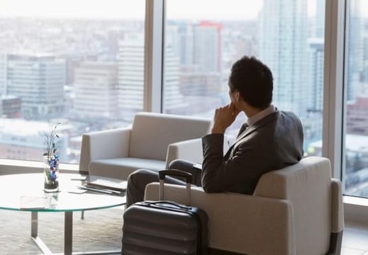 Person looking out window in airport lounge