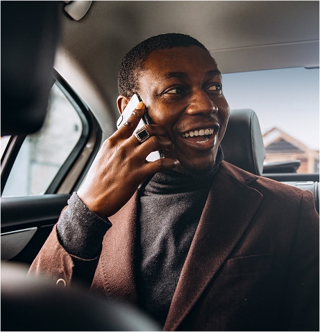 A person in a car talking on a cell phone