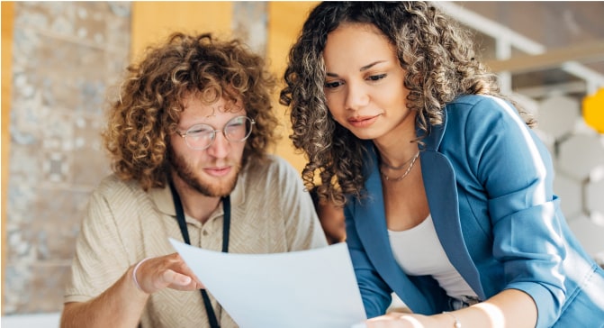 A person and person looking at a piece of paper