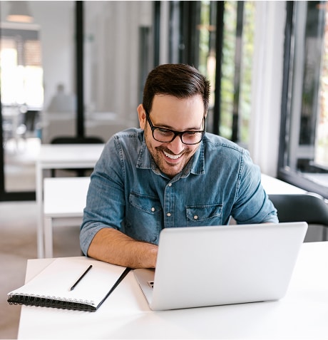 A person smiling at a computer