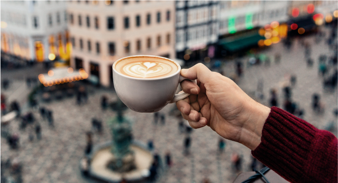 A person holding a cup of coffee