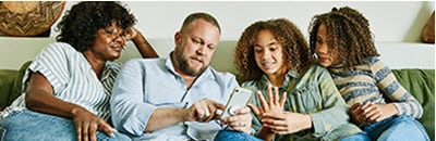 Family looking at mobile phone