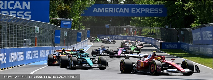 Action shot of F1 race with an American Express banner in the background.