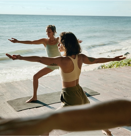 A group of women doing yoga on a beach