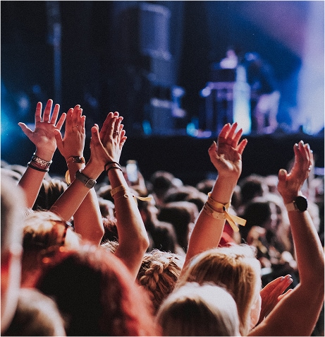A crowd of people raising their hands