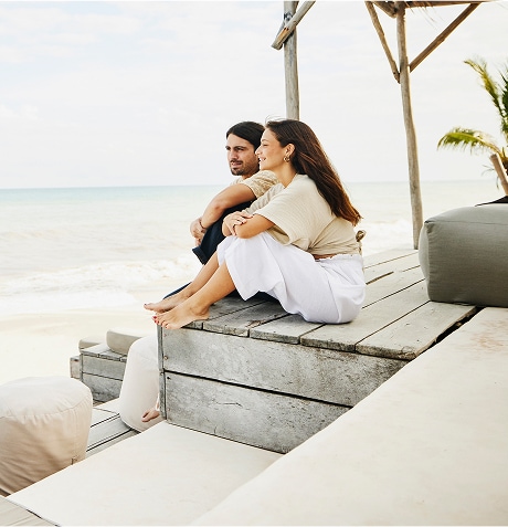 A person and person sitting on a wooden platform