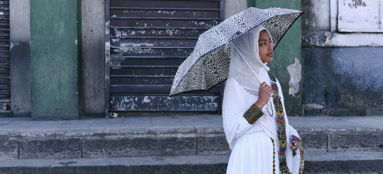 Person gazing into the distance while standing outside