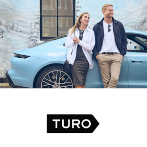 two kids running towards the camer with Warwick Castle behind them